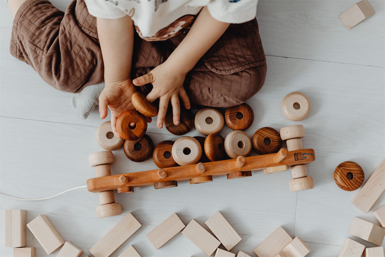A child exploring natural wooden learning materials